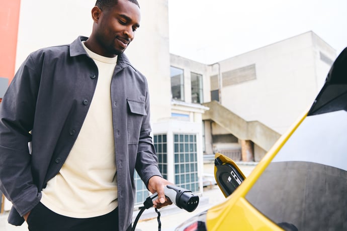 A driver plugs in an electric vehicle