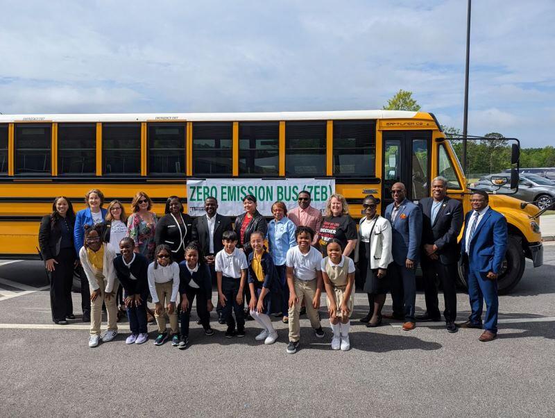 Clayton County students pose with electric school bus